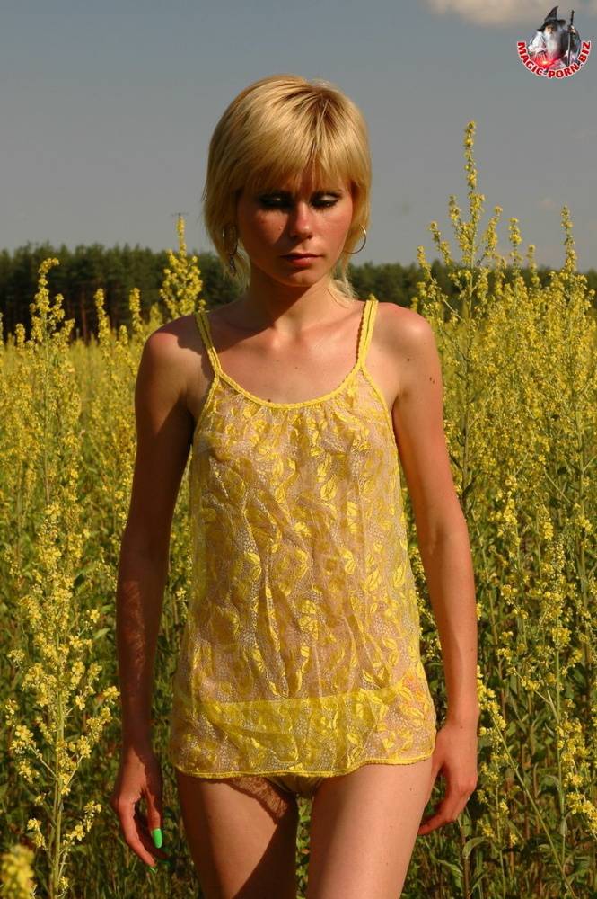 Young looking blonde girl shows her skinny body amid blooming wild flowers - #9