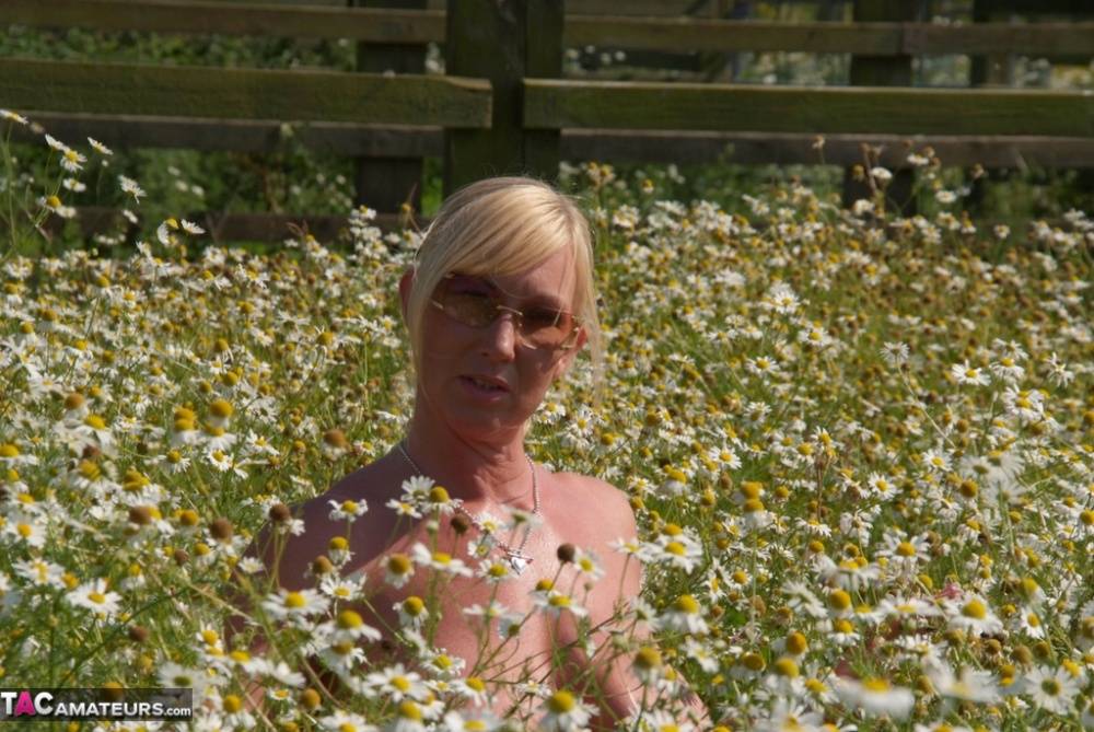 Overweight blonde Melody uncups her large boobs in a field of wild flowers - #10