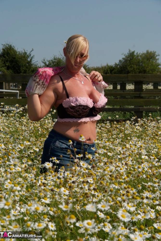 Overweight blonde Melody uncups her large boobs in a field of wild flowers - #13