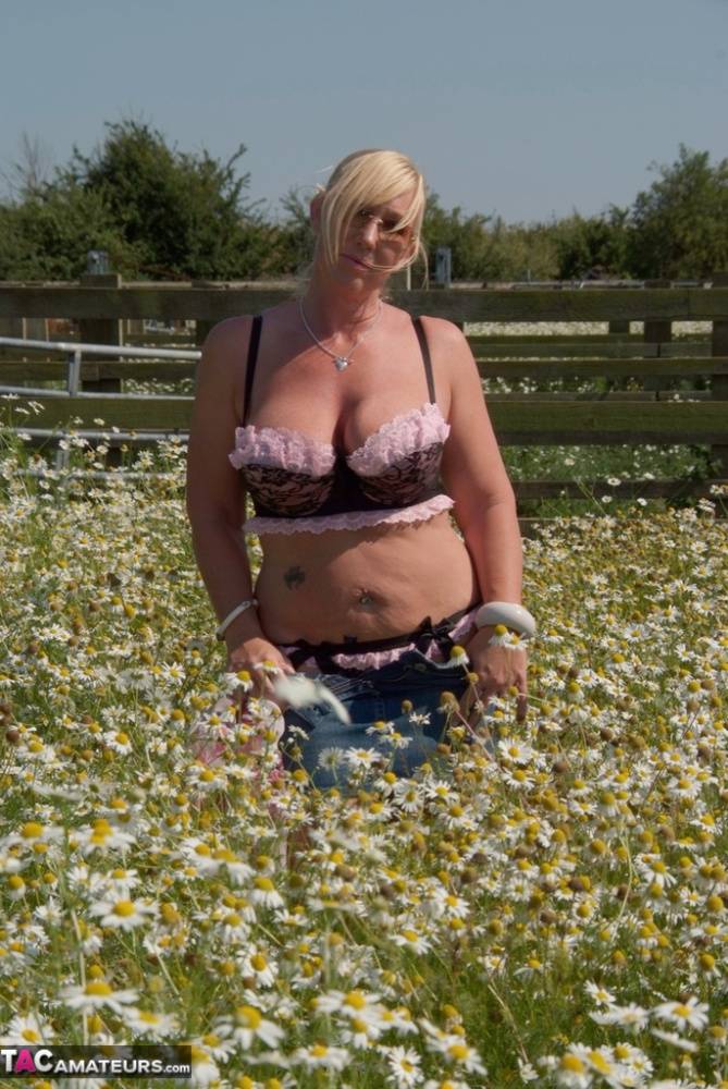 Overweight blonde Melody uncups her large boobs in a field of wild flowers - #14