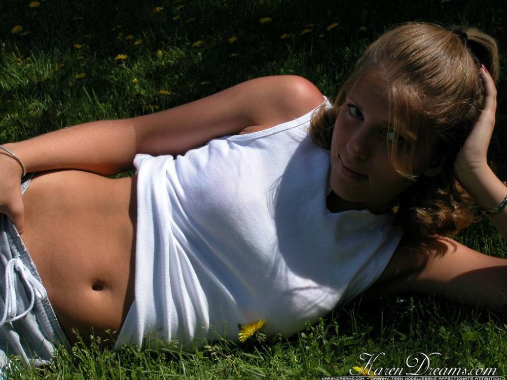 Cute blonde teen Karen lounging on the grass teasing non nude in shorts - #11