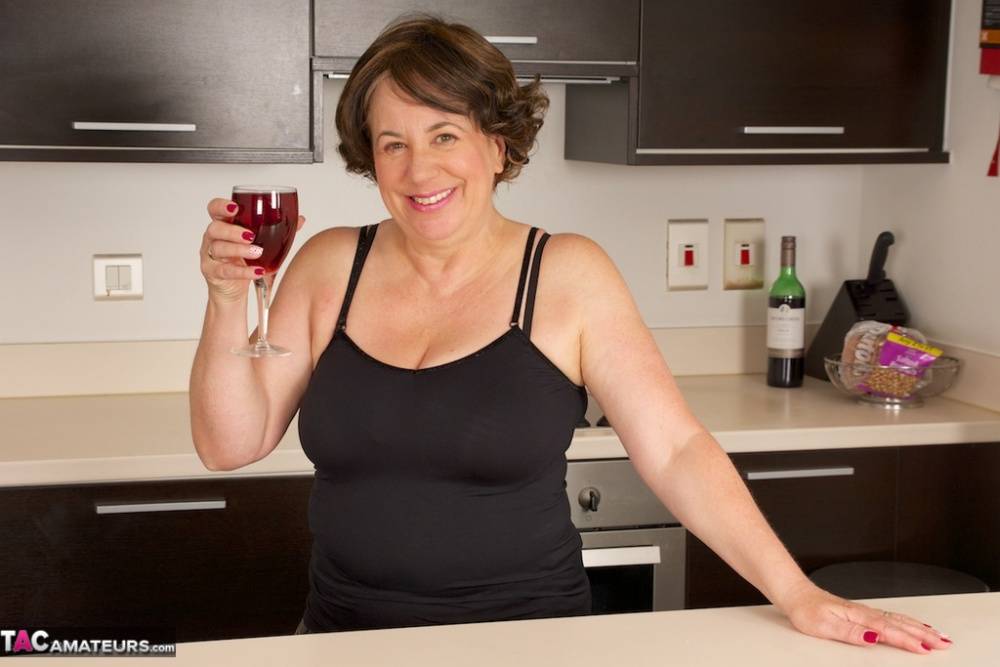 Older amateur raises a toast before baring her big tits on a kitchen counter - #5