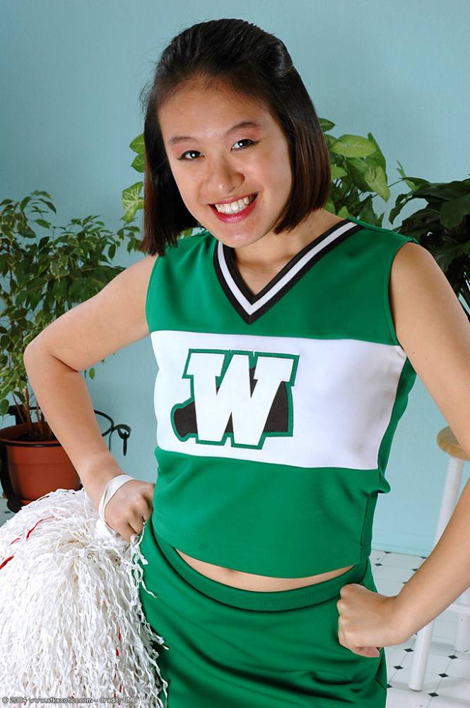 Amateur Asian freeing big tits and ass from beneath cheerleader uniform - #15