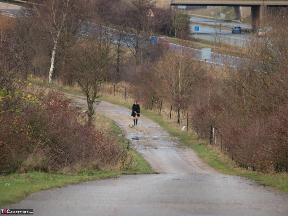 Overweight woman Roxy exposes herself while walking a path in black boots - #10