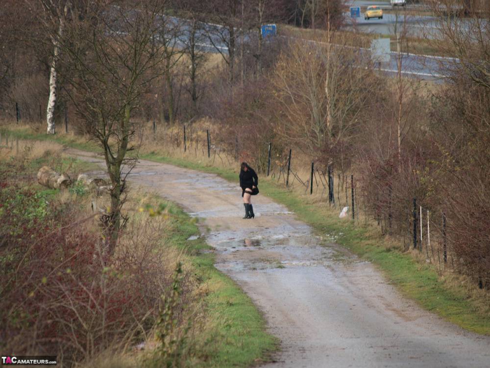 Overweight woman Roxy exposes herself while walking a path in black boots - #2