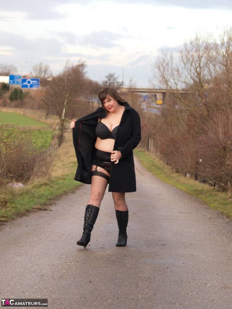 Overweight woman Roxy exposes herself while walking a path in black boots - #13