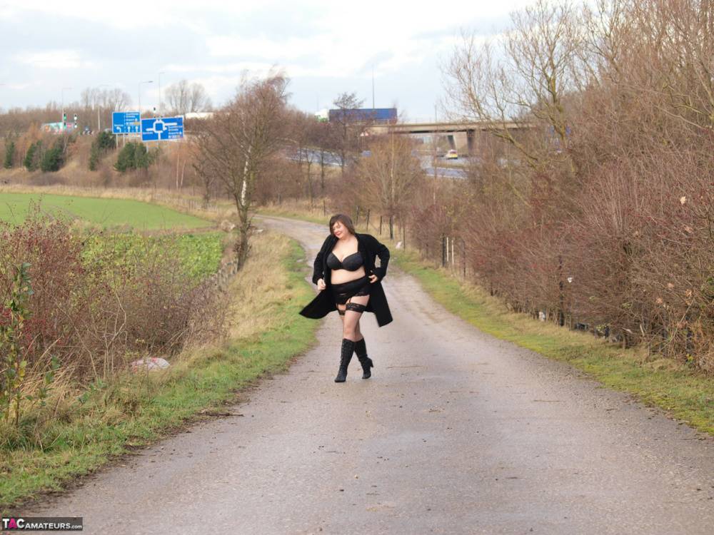 Overweight woman Roxy exposes herself while walking a path in black boots - #7