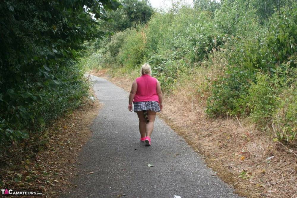 Fat UKwoman Lexie Cummings walks a path sporting a raccoon tail butt plug - #8