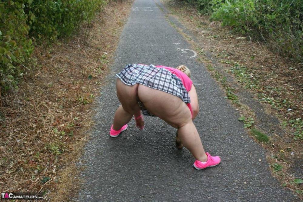 Fat UKwoman Lexie Cummings walks a path sporting a raccoon tail butt plug - #2