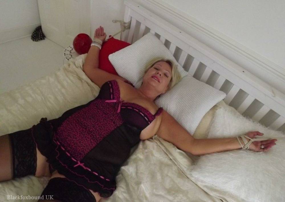 Busty older blonde is left tied up and gagged in numerous outfits - #10