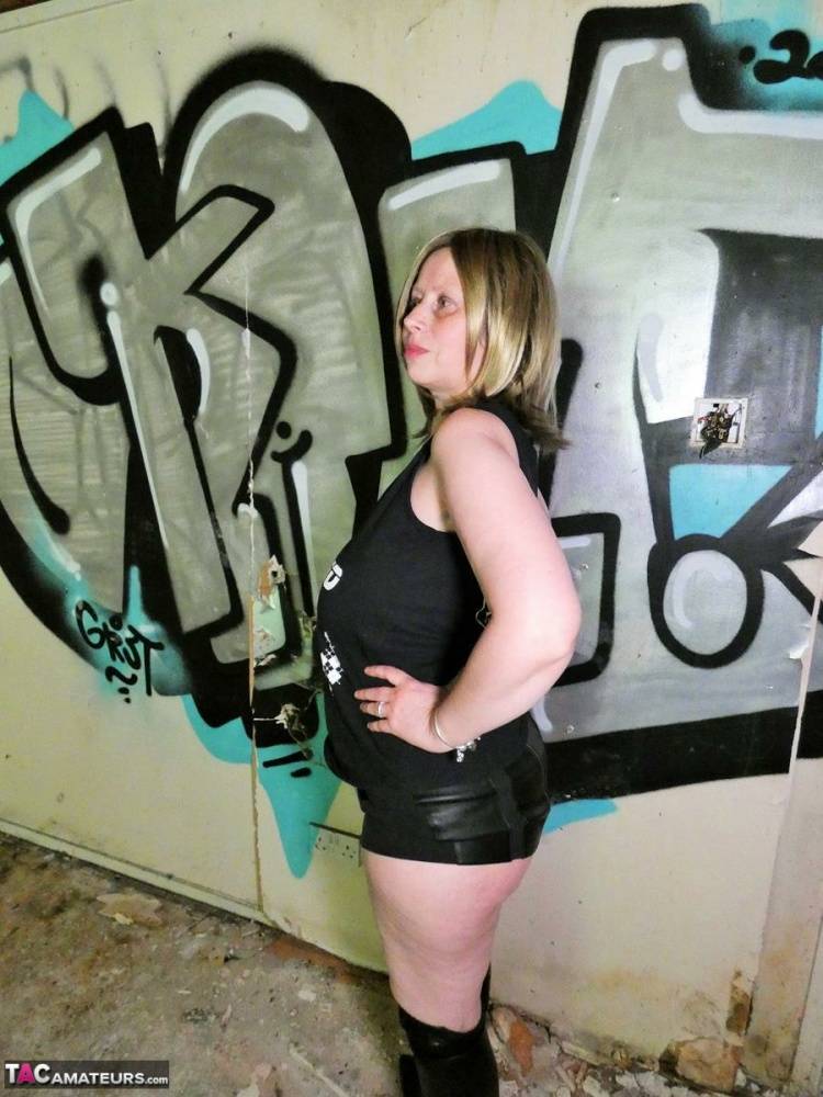 Older amateur Posh Sophia shows her large tits in a graffiti strewn building - #1