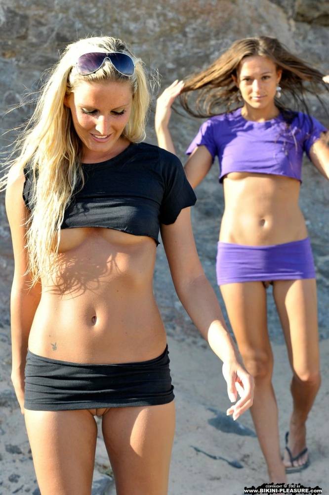 Two girls expose their underboobs and shaved pussies on a sandy beach - #10