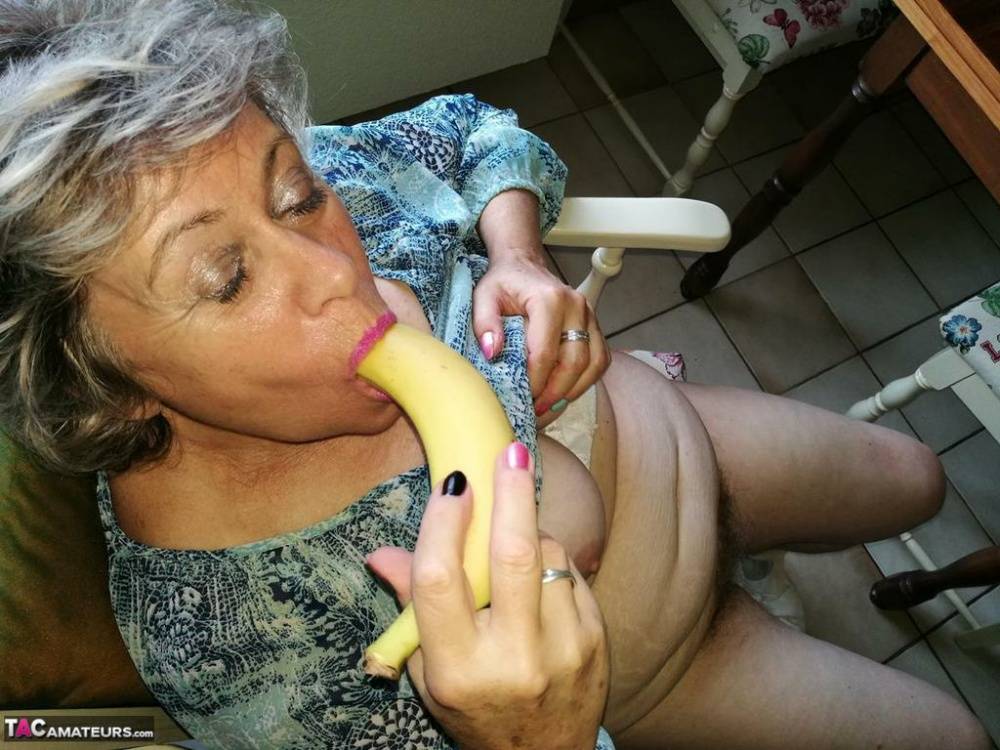 Horny granny Caro sticks a banana inside her natural pussy on kitchen chair - #8