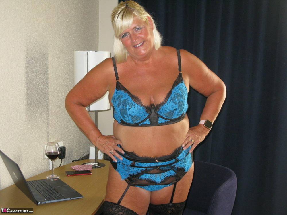 Mature BBW Chrissy Uk bares her boobs and twat at a desk over a glass of wine - #11