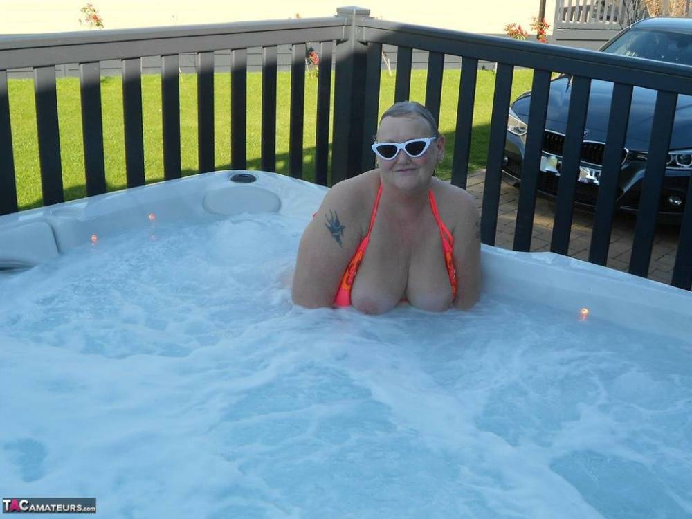 Fat nan bares her boobs while in a patio hot tub before getting naked on a bed - #9
