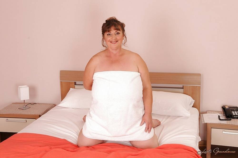 Mature plumper with huge saggy jugs and hairy cooter posing on the bed - #2