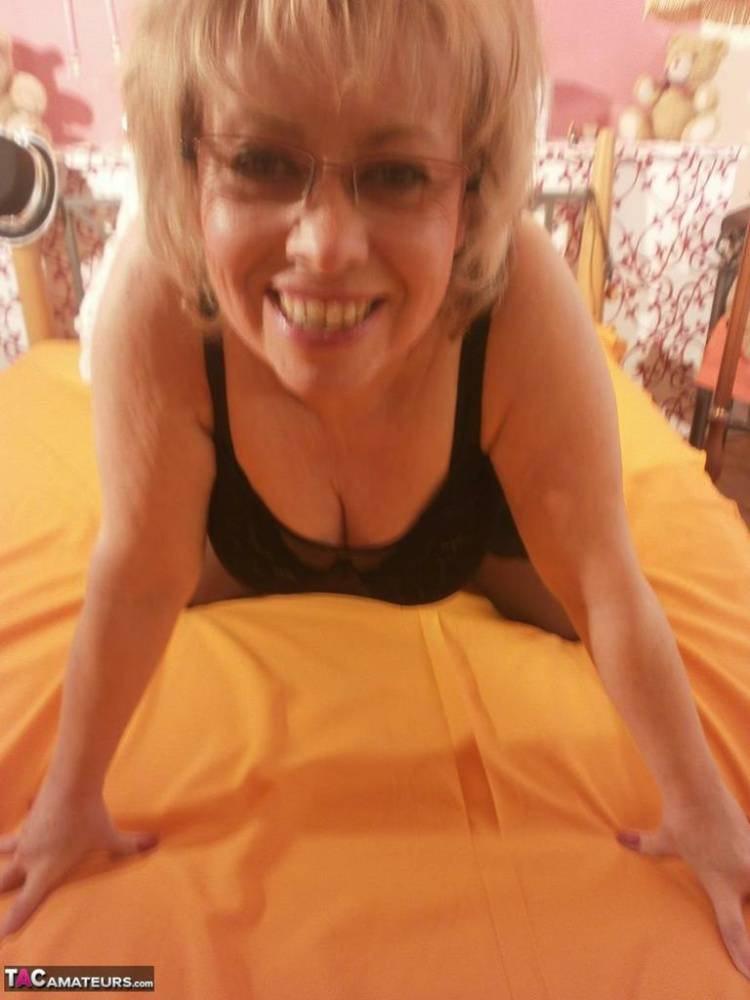Tipsy hot granny Caro spreading legs on the bed wearing black stockings - #4
