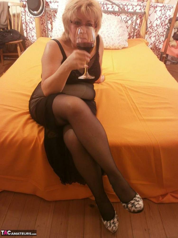 Tipsy hot granny Caro spreading legs on the bed wearing black stockings - #8