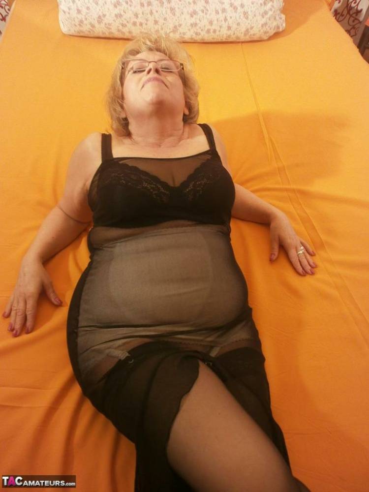 Tipsy hot granny Caro spreading legs on the bed wearing black stockings - #12