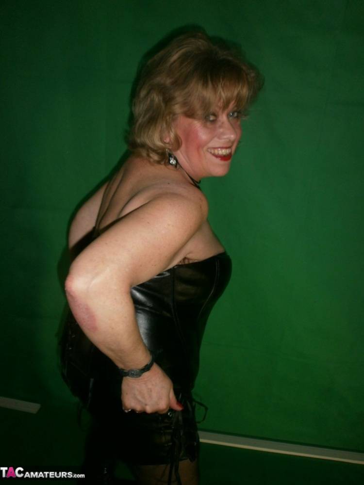 Mature blonde Caro fingers her snatch in ripped hose and leather apparel - #12