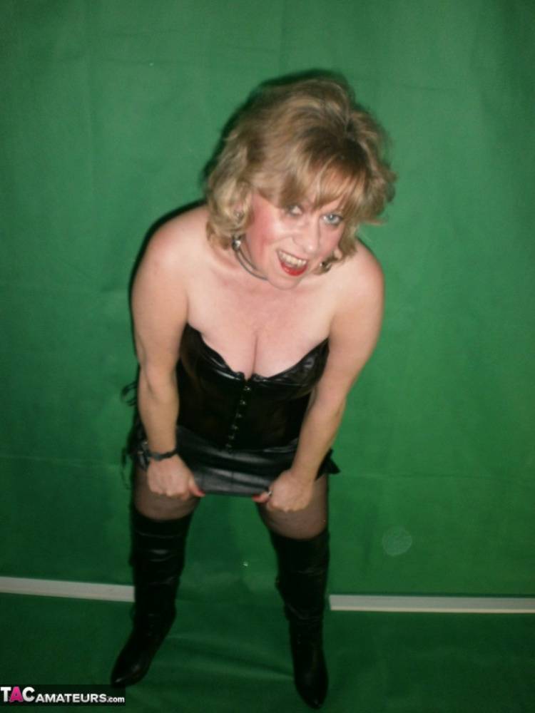 Mature blonde Caro fingers her snatch in ripped hose and leather apparel - #11