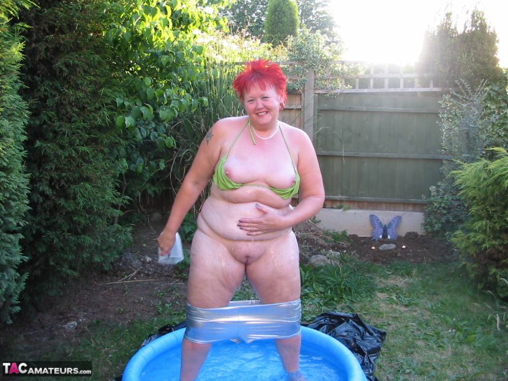 Older redheaded BBW Valgasmic Exposed plays with a dildo in a wading pool - #12