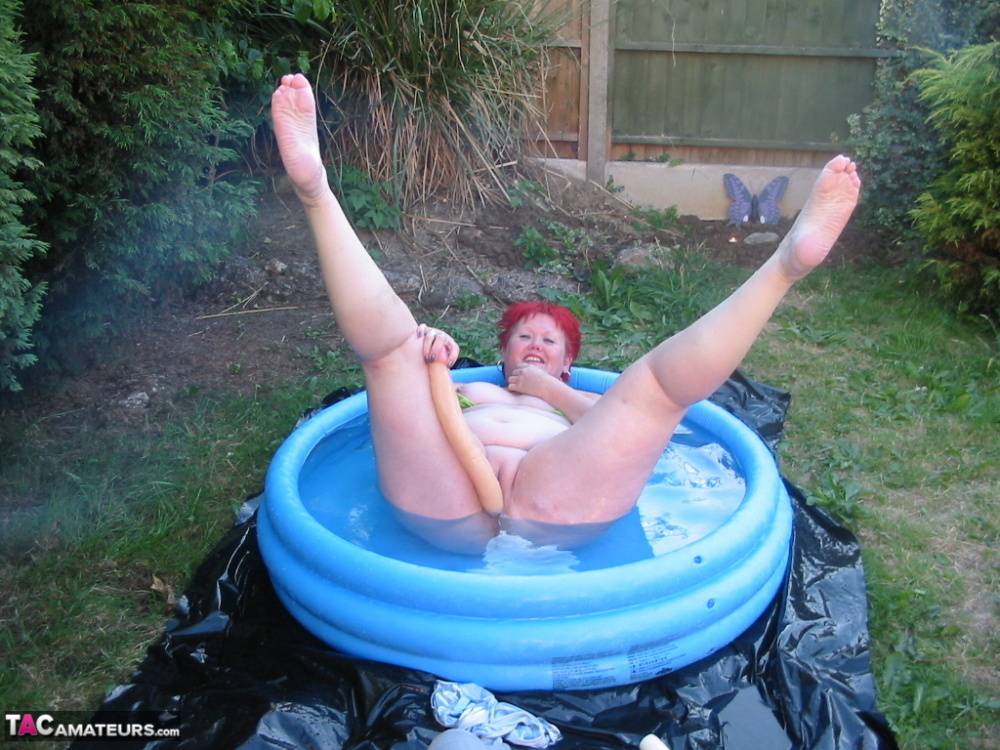 Older redheaded BBW Valgasmic Exposed plays with a dildo in a wading pool - #16