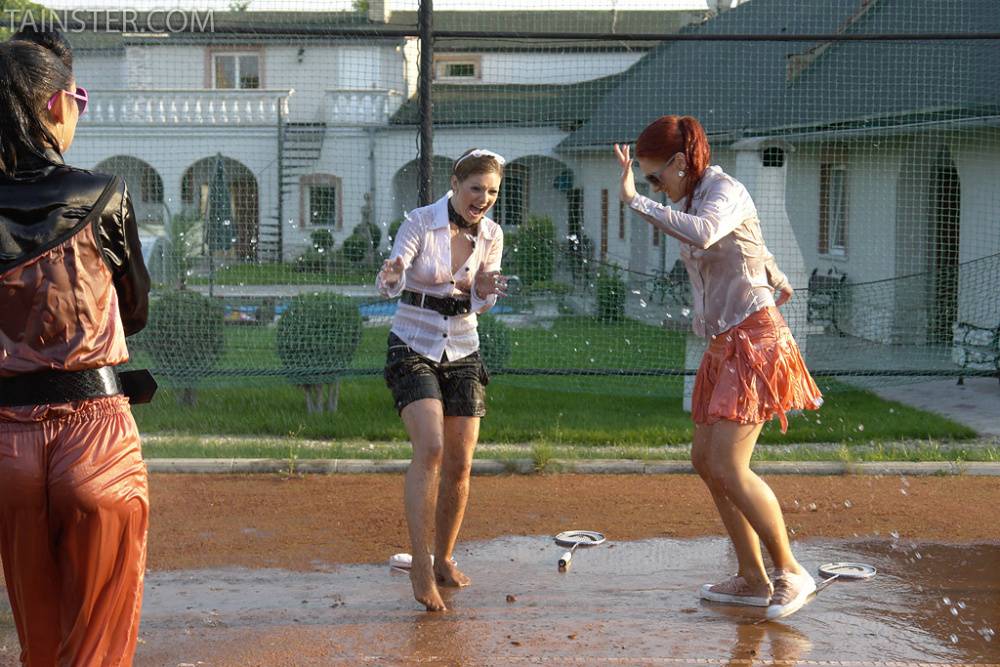 Seductive fully clothed fetish babes having some wet fun outdoor - #2