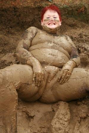 Older redhead Valgasmic Exposed rolls around in a mud pit while totally naked - #main