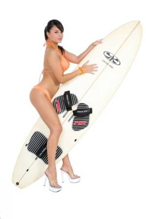 Sexy surfer girl Sarah peels off her bikini to model naked on her board on amateurlikes.com