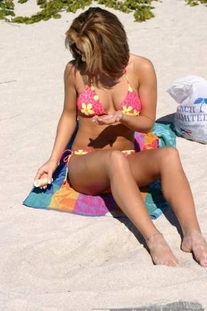 Teen solo girl Karen relaxes at the beach in a bikini and sunglasses on amateurlikes.com