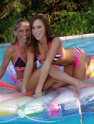 Lesbian girls Karen and Kate fondle each other while wearing bikinis in a pool on amateurlikes.com