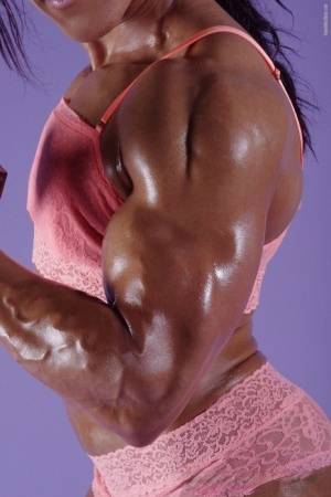 Female bodybuilder Karen Garrett flexes her muscles in lingerie on amateurlikes.com