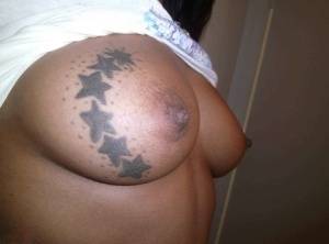Ebony amateur takes self shots of her big tattooed boobs and bald vagina on amateurlikes.com