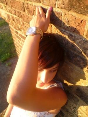 Girl next-door type Roxy shows off her new watch while outside her home on amateurlikes.com