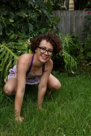 Geeky girl Rosie wears her glasses for her nude debut on the back lawn on amateurlikes.com