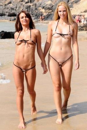 Best friends model revealing bikinis while wondering about a mud flat on amateurlikes.com