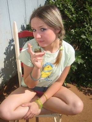 Cute teenage babe Shelby takes a smoke break and flashes us her perky tits on amateurlikes.com