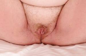 Mature plumper with huge saggy jugs and hairy cooter posing on the bed on amateurlikes.com