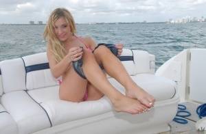 Lusty blonde Amy Brooke strips bikini and rubs pussy on the boat on amateurlikes.com