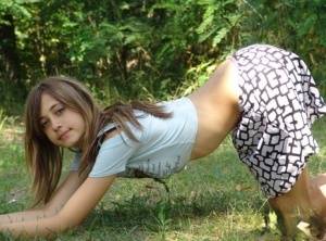 Shapely young teen in tiny t-shirt and short skirt posing outdoors on amateurlikes.com